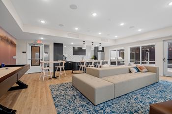 a living room with a couch and a table with chairs
